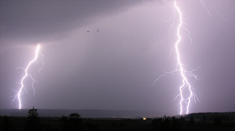 A cloud-to-ground lightning strike during a night thunderstorm