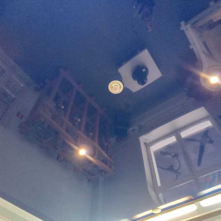 A photoelectric smoke alarm mounted on a ceiling