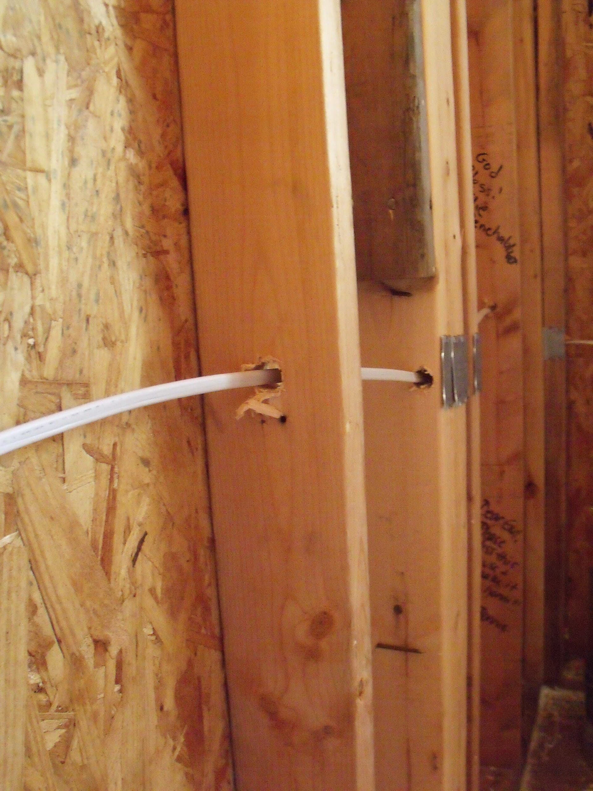 Electrical wiring rough-in with cables run through timber framing
